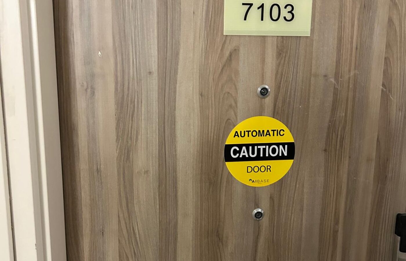 Automatic door marked with a caution automatic door decal