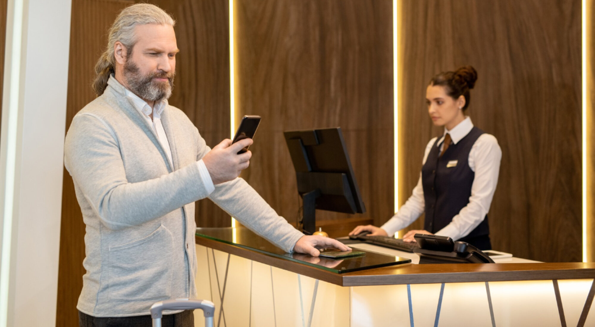 Guest checking in at a hotel front desk
