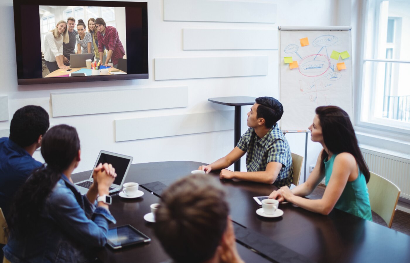 Team meeting with remote participants on screen